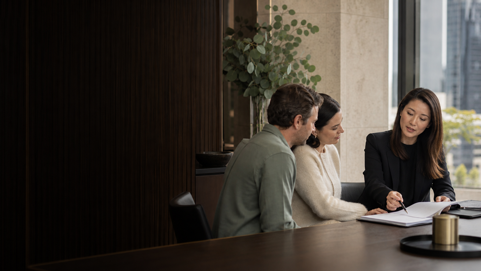 A conveyancing lawyer reviewing property documents with clients in Melbourne